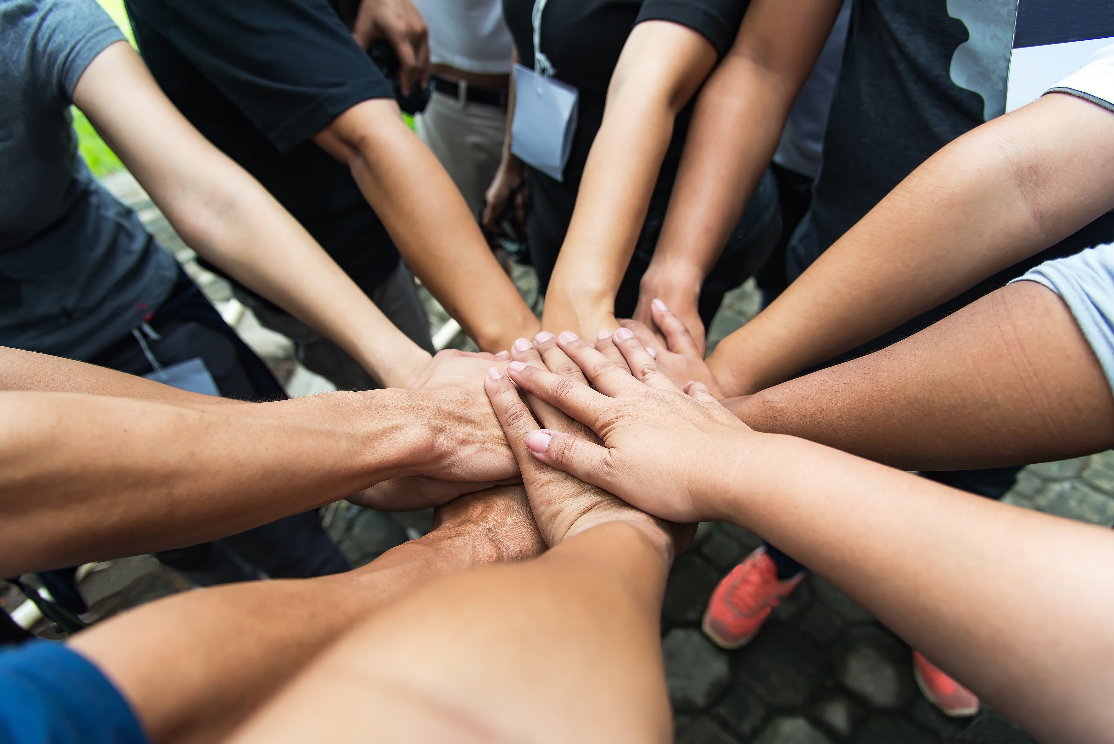 Hands reaching together in support